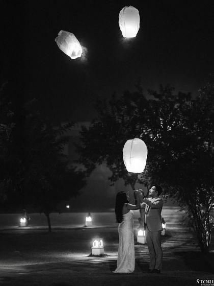 A magical black and white shot of the couple releasing sky lanterns at night in Varanasi, creating a dreamy and symbolic image.