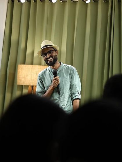 A performer enjoys the show from the audience, showcasing the community spirit.