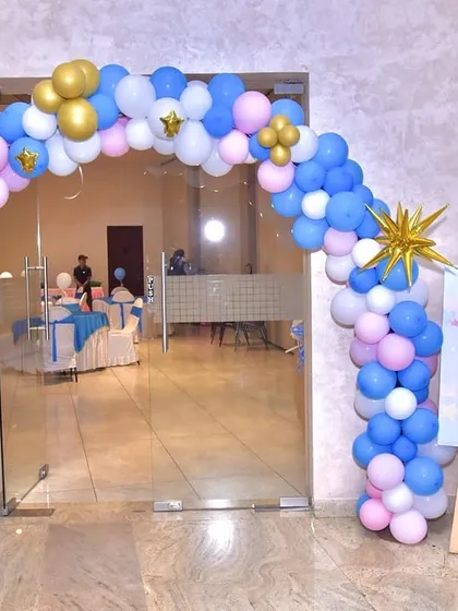 An identical shot of the welcoming entrance arch for Vani's party.