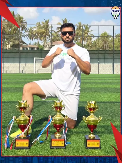 Our Technical Director, Coach Awais Shaikh, posing with the three trophies, symbolizing our academy's successful campaign.
