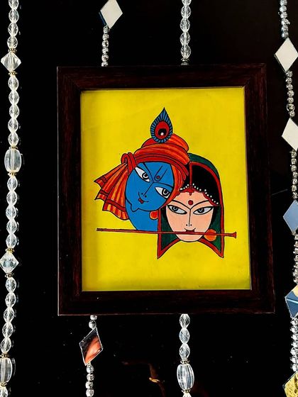 This small, 9x10 inch framed painting of Radha and Krishna is perfect for a small space. I used a bright yellow background to make their profiles stand out, creating a simple and heartfelt piece.