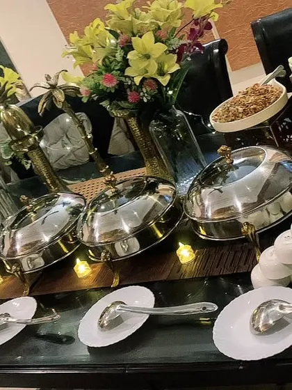A beautiful, candle-lit buffet arranged on a dining table for a house party of 30. This shows how I can transform your home dining area into a professional catering space.