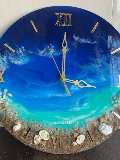A beautiful ocean clock with deep blue water and a shoreline made with real sand and shells.