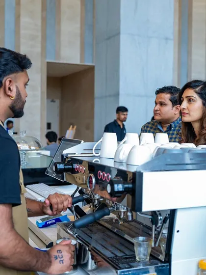 A customer places an order at our Bellandur espresso bar. Our baristas are always happy to help you choose your perfect drink.