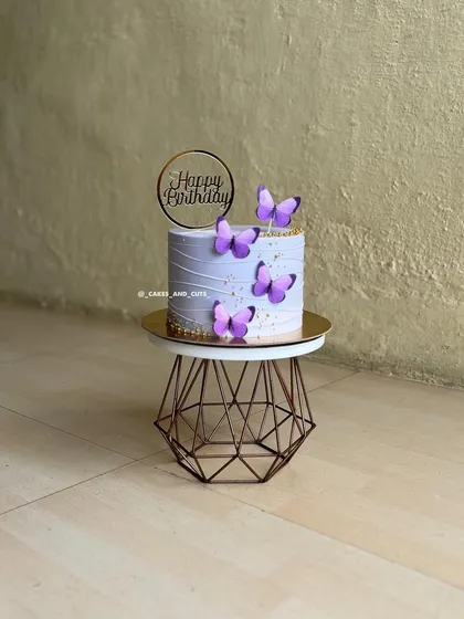 A simple yet pretty purple butterfly cake with a "Happy Birthday" topper.