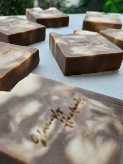 A close-up of a Neem Cucumber bar, showing my "Gloriously Handmade" stamp. This soap is wonderful for calming and clarifying the skin.