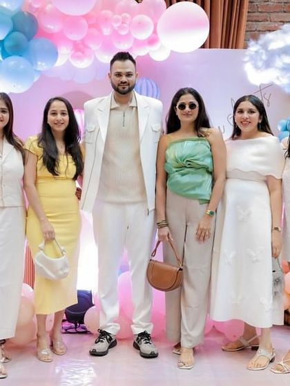 The dad-to-be posing with friends at the baby shower. It’s wonderful to see everyone dressed to match the theme and sharing in the couple's happiness.