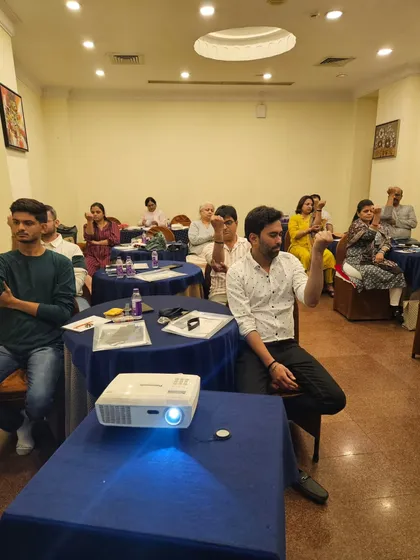 Participants practicing a mudra (hand gesture) during the Aura & Chakra workshop to balance their energy.