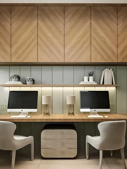 A work-from-home setup designed for two. This modular unit features a long, shared desk, overhead cabinets with a chevron wood pattern for concealed storage, and a backlit open shelf for easy access to essential items, creating a productive and organized home office.