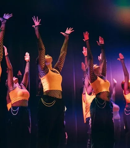 A beautiful moment of unity in 'The Sabi's' performance, with hands raised in a gesture of expression and connection.