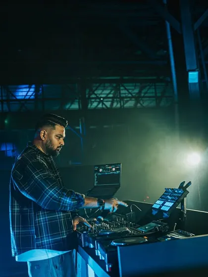 In the zone at the Homegrown Festival, surrounded by atmospheric blue lighting and haze. This is me focused on crafting the perfect set.