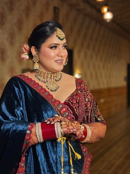 The bride looking elegant and poised. The makeup enhances her features, giving her a confident and regal look.