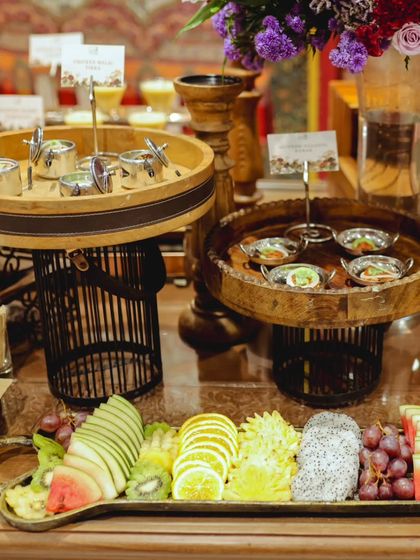 A wider view of the fruit and appetizer station, showcasing the multi-level display stands and the variety of offerings available to guests.