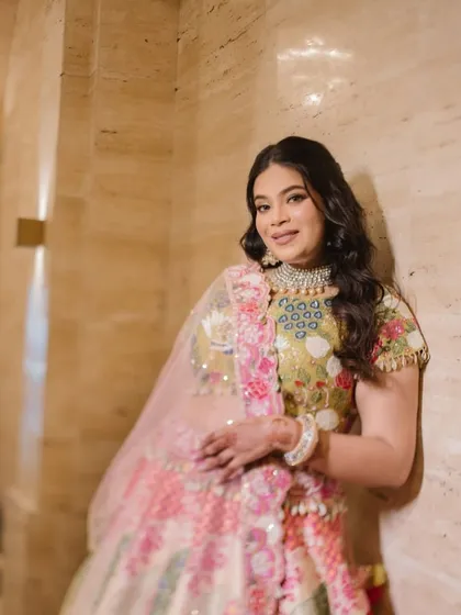 For a vibrant Mehendi or Haldi ceremony, the makeup should be just as joyful. This look features fresh, glowing skin and bright eyes, perfectly matching the colorful floral lehenga and the happy occasion.