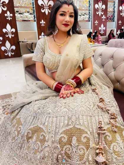 A series of photos of my happy client looking absolutely stunning in a heavily embroidered silver-grey lehenga at her reception. She owned the look completely!