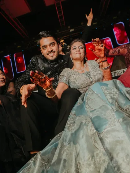 The couple enjoying the Sangeet from a special seating area on the stage, giving them the best view of the performances.