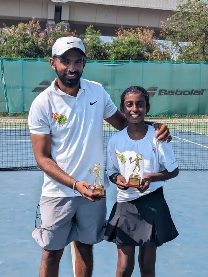 Trisha Bhosale with her coach, holding trophies for Singles Runner-up and Doubles Winner at the U-12 All India Ranking Championship Series in Kalina.