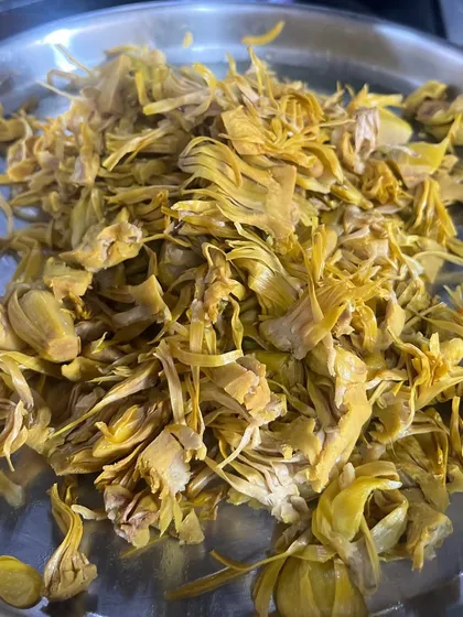 Shredded raw jackfruit, ready to be cooked. This is the base of our thoran, prepared to absorb the fragrant spices and coconut that will make it a star dish.