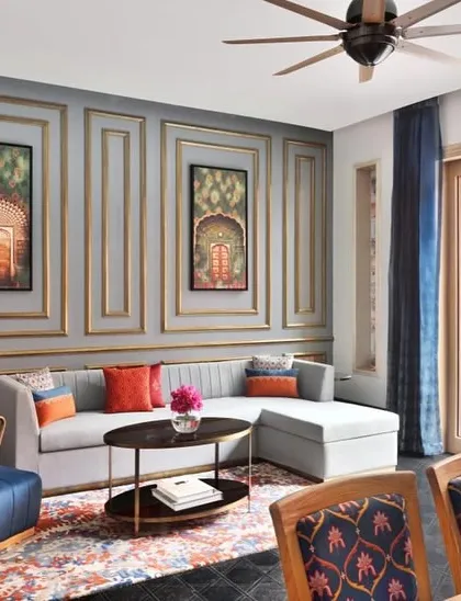 A private villa suite at Taj Devi Ratn with direct access to a plunge pool. The interior design balances comfort with elegance, using a soft grey palette accented with rich colors and traditional artwork to create a serene personal haven.