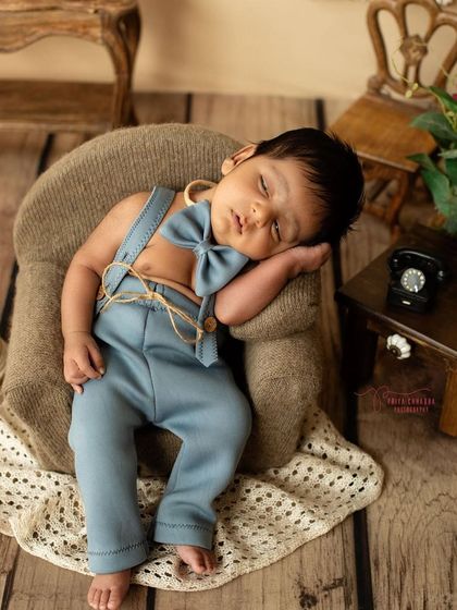 Napping on the job. This little dreamer looks so peaceful sleeping on a miniature armchair, dressed in a dapper outfit.
