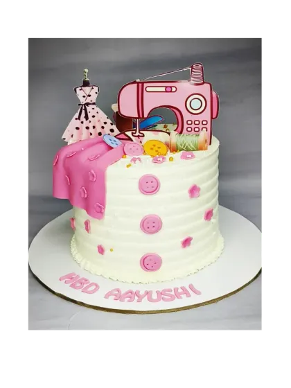 A cake for a fashion designer, featuring a sewing machine and dress form. This is a butterscotch caramel cake with fresh whipped cream.