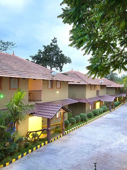 A row of cottages at Coorg Cliffs Resort, showing the beautiful layout and the lush greenery that surrounds the property.
