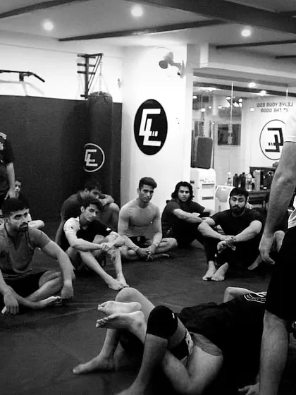 A coach breaks down a grappling technique for the class. We make sure everyone understands the 'why' behind the move, not just the 'how', to build true fight IQ.