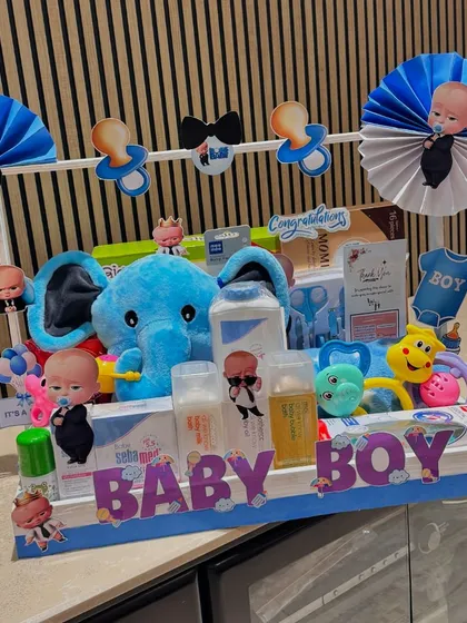 This Boss Baby themed hamper is perfect for welcoming a new baby boy. The blue elephant and pacifier garland add to the playful and cute design.