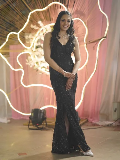 Look stunning at your next cocktail party or reception with our collection of evening gowns. This client is rocking a fully sequined black mermaid gown, a timeless choice for any glamorous event. Renting a party wear dress means you never have to repeat an outfit.