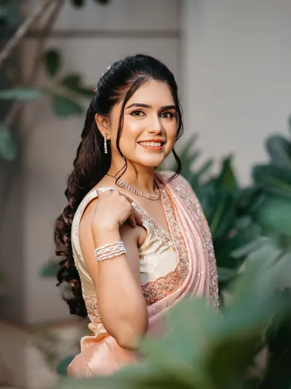 A happy and confident bride. The half-up, half-down hairstyle is romantic and modern, pairing beautifully with the soft glam makeup.