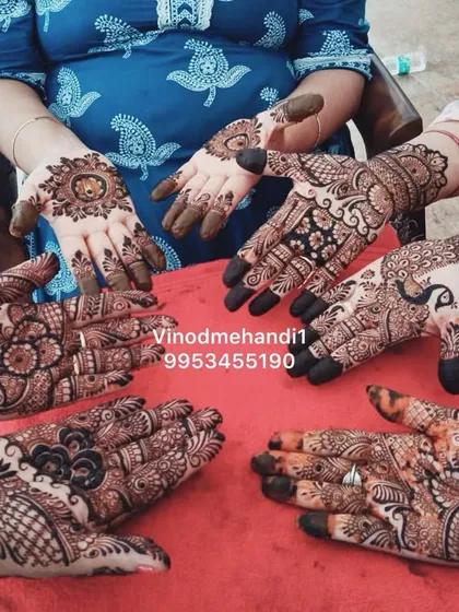 A group photo from a mehandi ceremony, showcasing different designs for the bride and her family. I can create a cohesive theme for your entire bridal party.