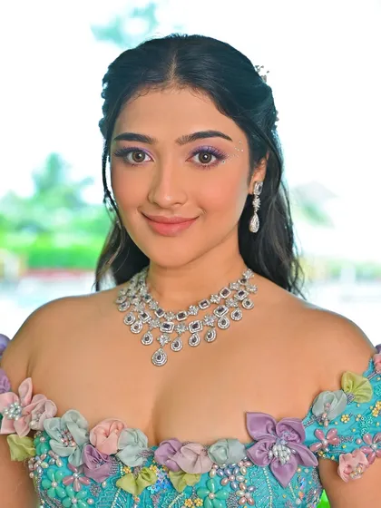 Embracing the magic of a carnival-inspired look. I created this enchanting style with a pop of purple on the eyes and a soft, romantic hairstyle.