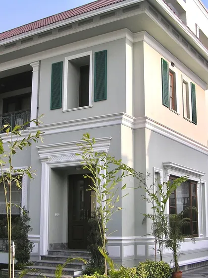 Another angle of the London-inspired villa, showcasing the clean lines and symmetrical balance that define its architectural character. The simple landscaping complements the formal structure.