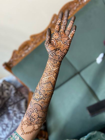 The back of the hand and arm, continuing the detailed patterns from the front. Every part of the design is carefully considered to create a complete piece of art.