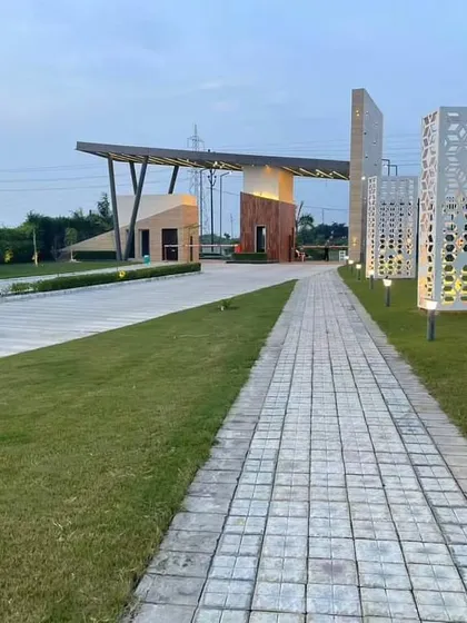 The completed entrance pathway for a housing community in Kanpur. We use a combination of hardscaping, softscaping, and strategic lighting to create a welcoming and impressive arrival experience for residents and visitors.