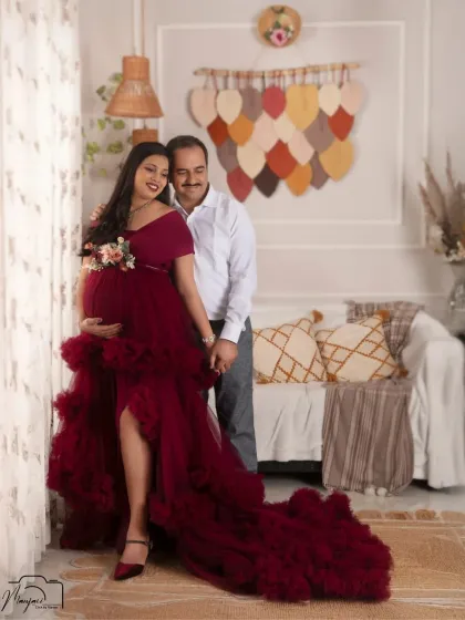 A romantic and elegant portrait of the couple by the window in the boho studio. The wine-colored gown is absolutely stunning.