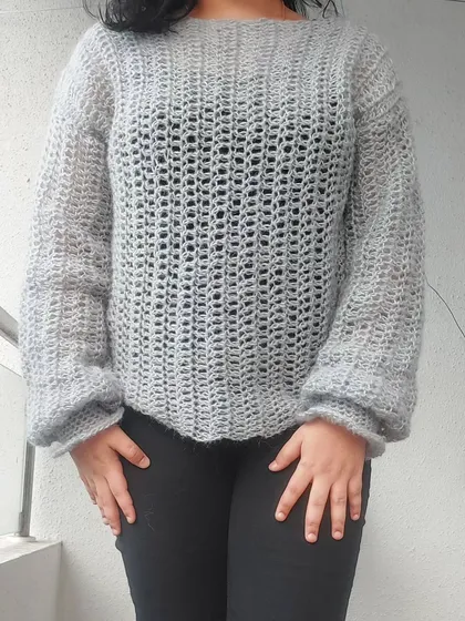 A full-length view of the Vevitha Sweater, showcasing its relaxed fit and elegant drape.