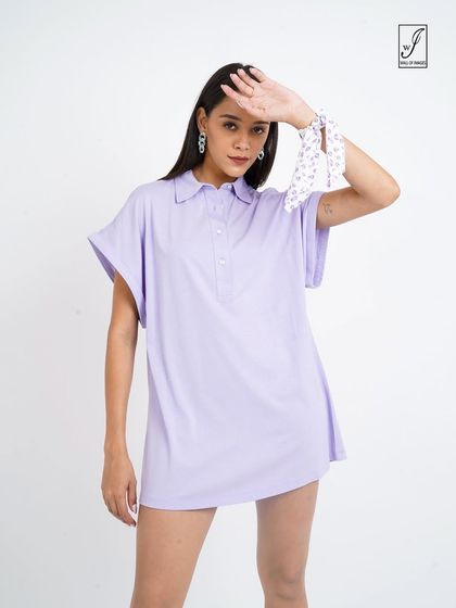 A pose that highlights the relaxed fit and simple design of the polo dress.