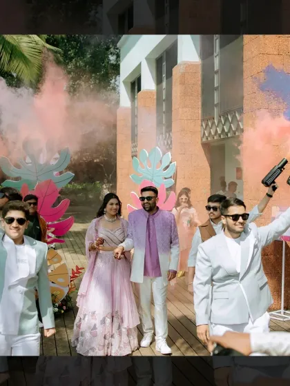 The couple's entry for the Haldi was a spectacle in itself. The wedding party, dressed in coordinated pastels, made their way through clouds of colored smoke, setting a fun and celebratory tone.