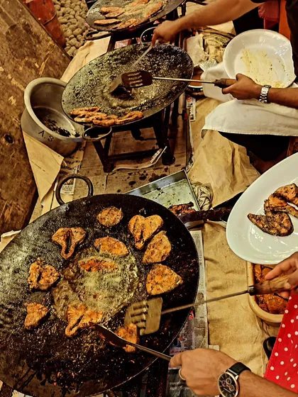 We bring the action to your event with live cooking stations. Our chefs are seen here preparing fresh Tandoori Seer Fish on a hot tawa, a favorite at weddings and sangeets.