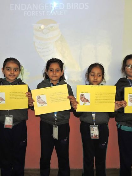 Students hold up their projects on endangered birds during our "Animal Care" sensitization program. We believe in teaching empathy and responsibility towards all creatures from a young age.