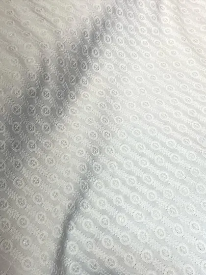 An elegant white-on-white Chikankari fabric with a circular embroidery pattern. This is a timeless option for a classic kurta pyjama set.