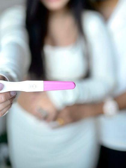 The big reveal. This close-up shot focuses on the positive pregnancy test, a powerful symbol of the new journey the couple is about to embark on.