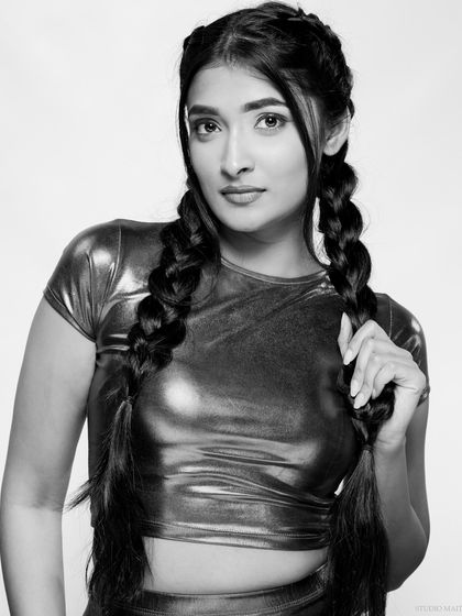 A black and white version of a fun, energetic portrait. The monochrome conversion gives this shot a classic, timeless feel, focusing on the model's expression.