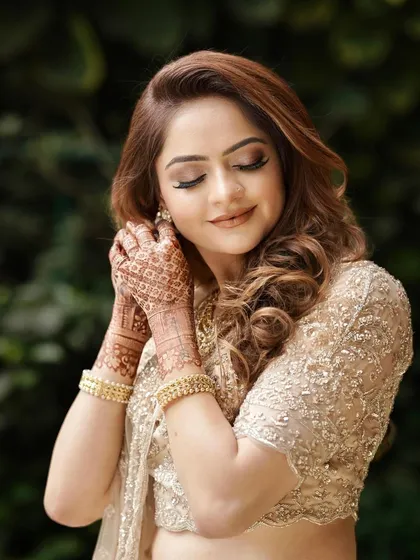 A candid moment capturing the beautiful details of this engagement look. The soft glam makeup enhances her natural beauty, with an emphasis on glowing skin and elegantly defined eyes.