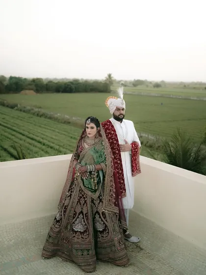 A classic, royal portrait of the couple against the backdrop of a beautiful, rural landscape.