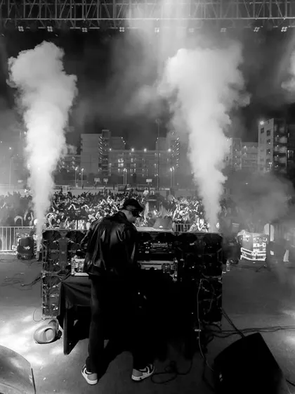 A dramatic black and white shot capturing the moment the CO2 jets fire off. This highlights the powerful production elements I incorporate to build hype and create unforgettable drops during my sets.