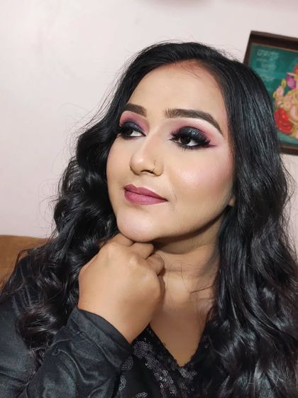 A thoughtful pose that highlights the defined cheekbones and the shape of the eye makeup.