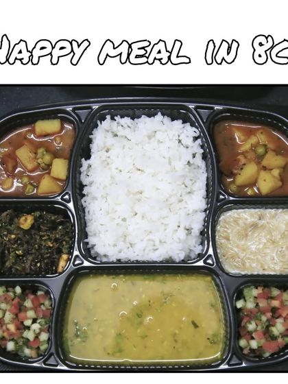 The 8-compartment thali is a full meal experience, with dal, rice, multiple sabzis, salad, a sweet, and other accompaniments.