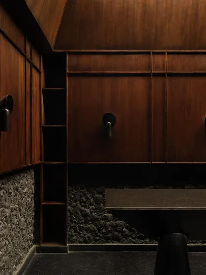 The private lounge, a sanctuary within the sanctuary. Here, dark wood paneling and leather seating create a warmer, more traditional atmosphere, offering a different chapter in the Lair's story.